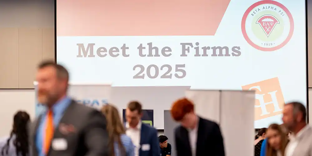 A photo of the "Meet the Firms" event in 2025, showing a number of attendees and displays.
