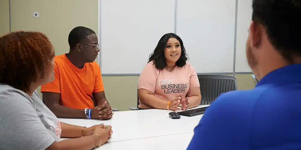 Business students meeting in a conference room.