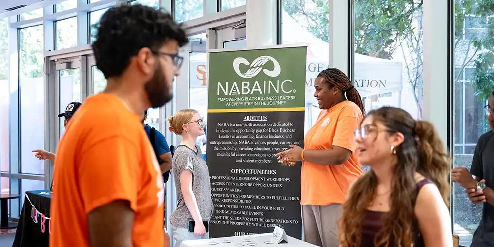 Students meeting and discussing business organization on campus.