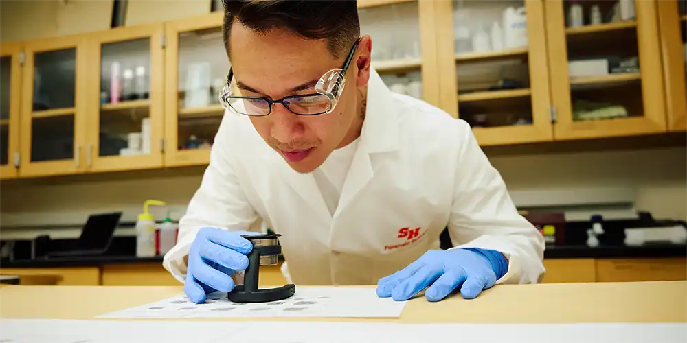 Forensic science student examines fingerprint images