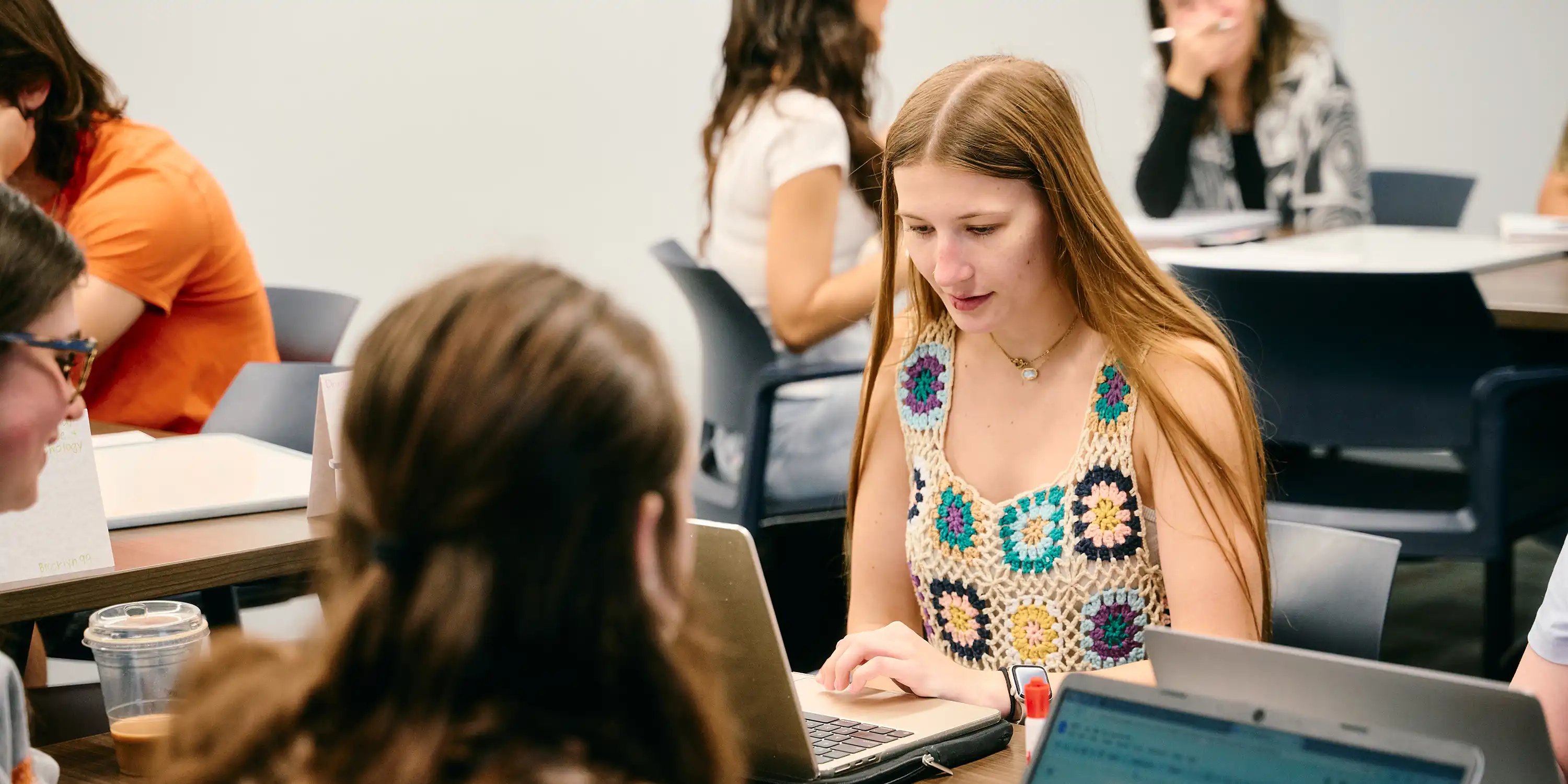 SHSU students speak with Frances Brandau, chair of Communication Studies, in her office.