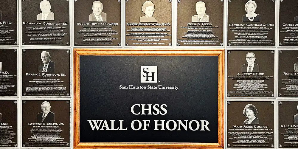 Wall of Honor plaques that hang in the College of Humanities and Social Sciences building.