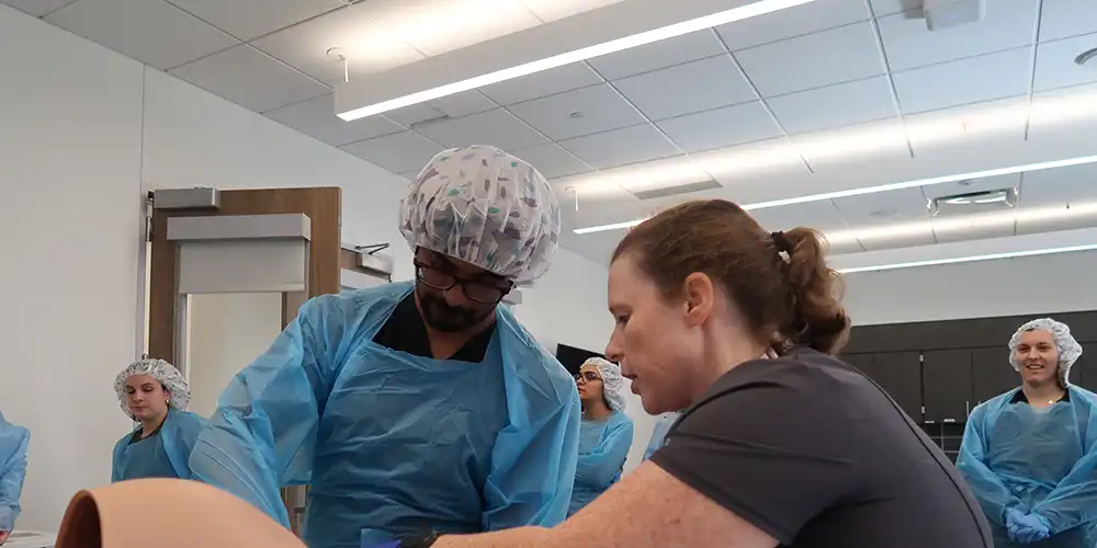 Dr. Potter teaching in the SIM hospital during a birthing simulation
