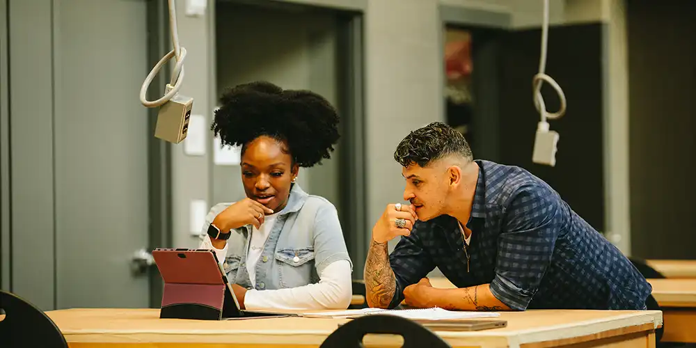 Students looking at laptop