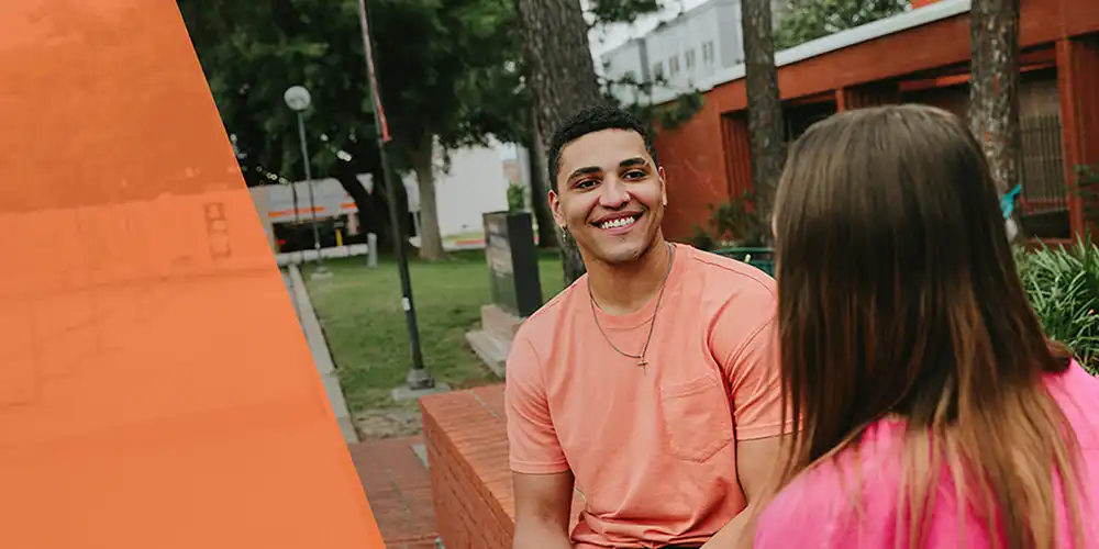 Two students sitting down together on campus