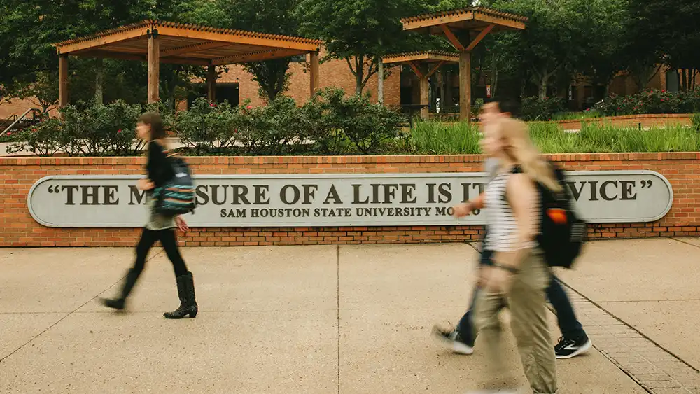 Man in suit talking to another man