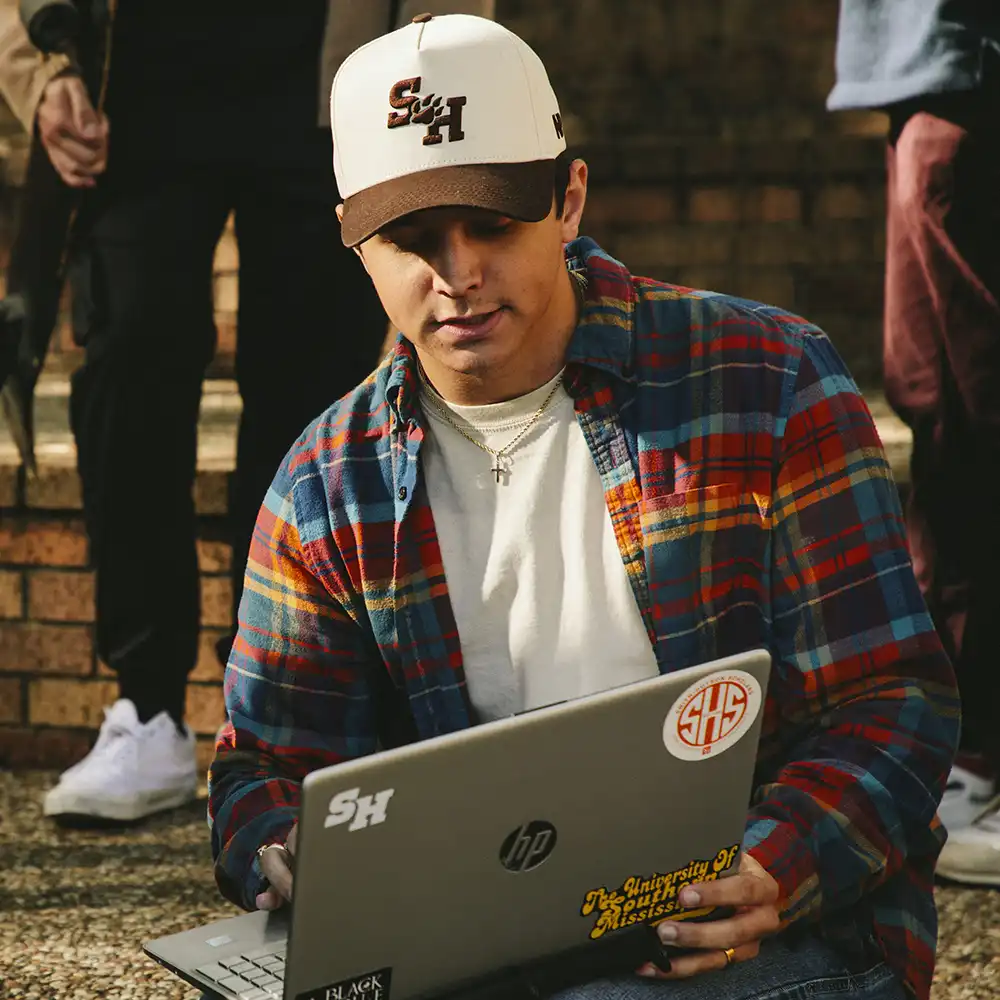 SHSU student discusses something on laptop. 