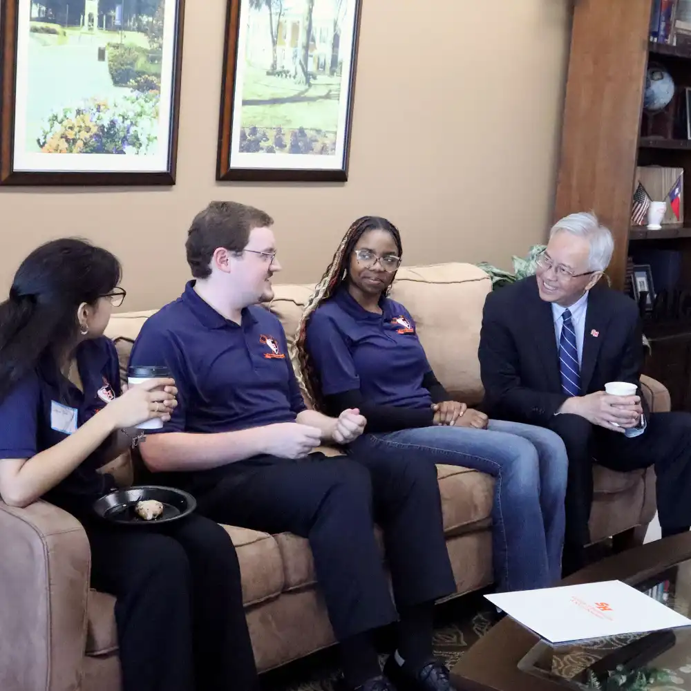 SHSU students in conversation with the Dean from the College of Humanities and Social Sciences.