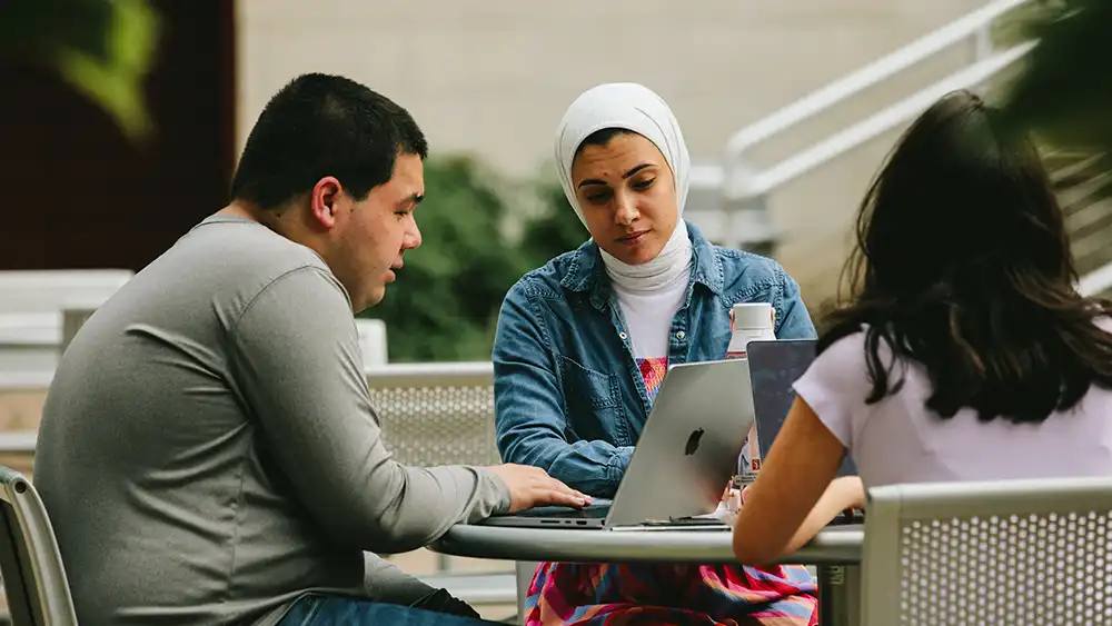 SHSU student smiles while in conversation on campus.