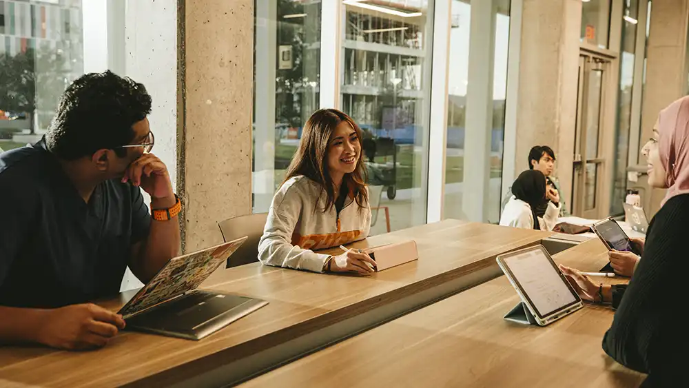 SHSU student smiles while in conversation on campus.