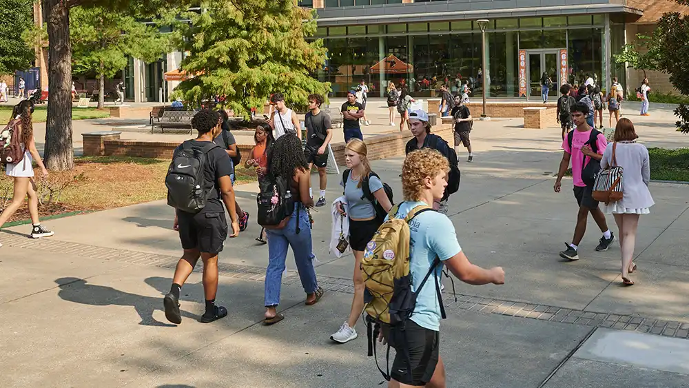 SHSU student studies in the plaza.
