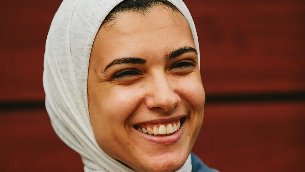 SHSU student smiles while in conversation on campus.