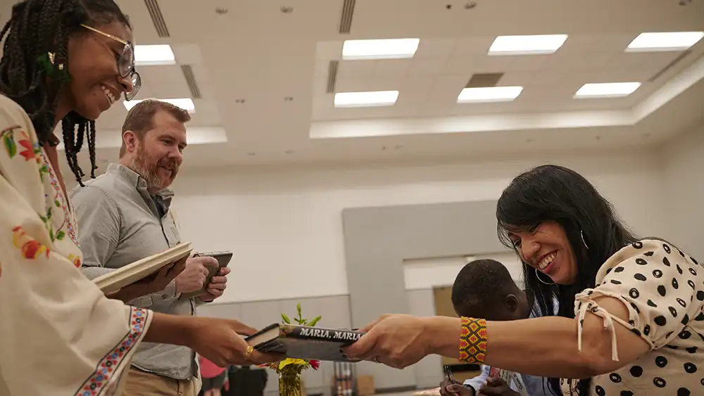 SHSU students and faculty interact with an author after a campus reading.