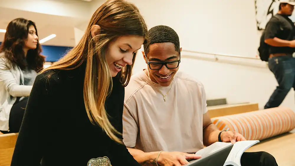 Male and female student working together.