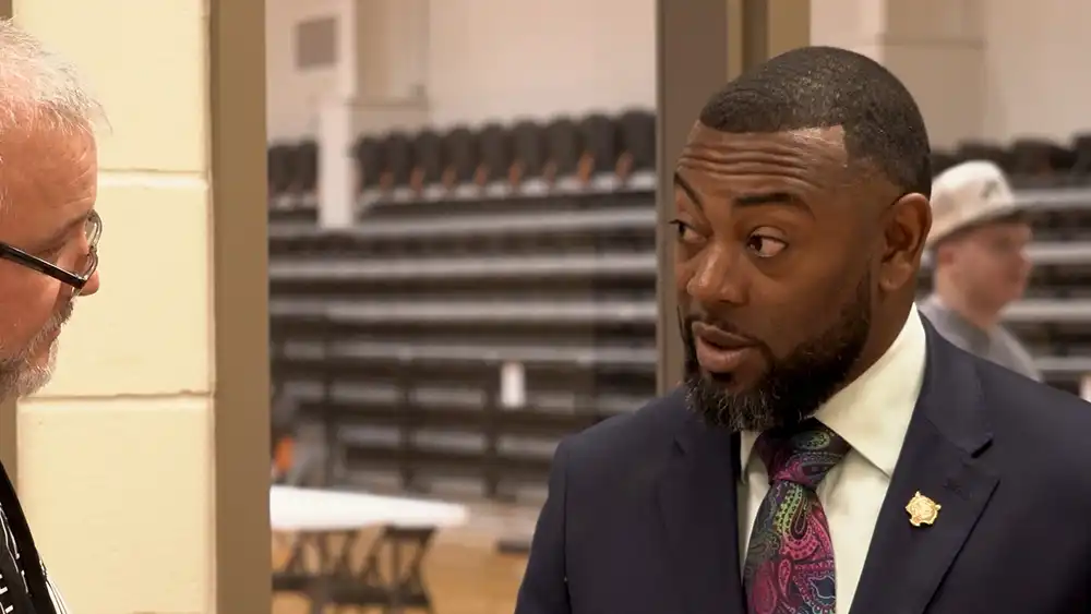 Man in suit talking to another man