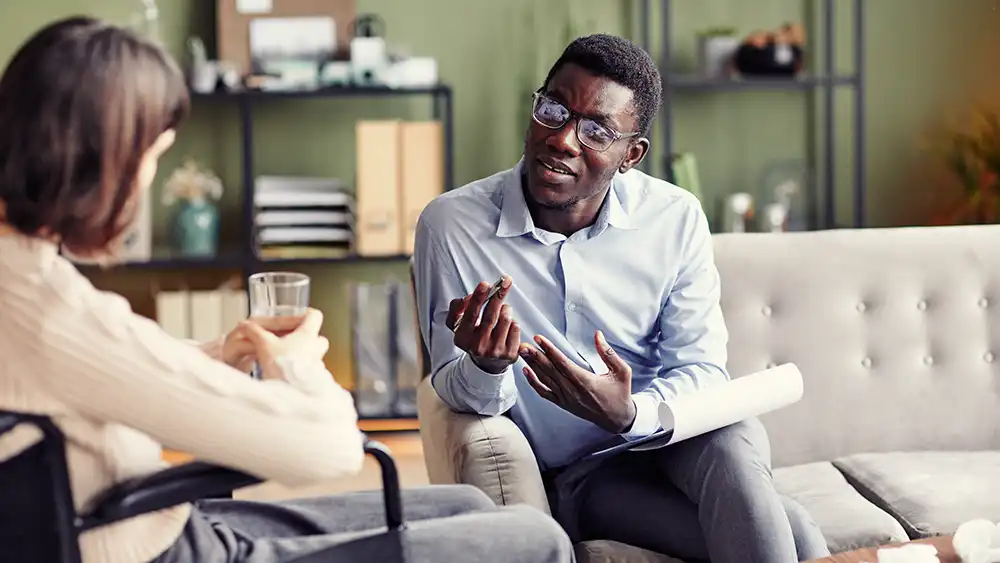 Man in suit talking to another man