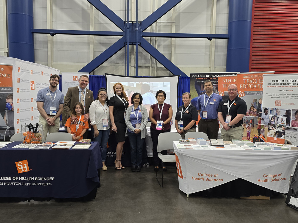 Professor speaking to the camera in a classroom style class, with her hands opened.