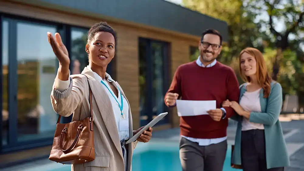 Real estate professional giving a home tour to two clients 