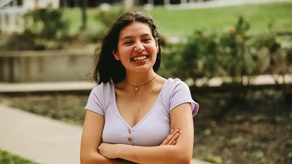 Female student outside looking at the camera.