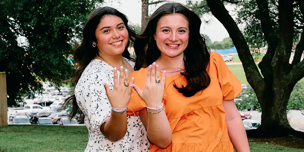 Two SHSU students showing off their Official SHSU rings