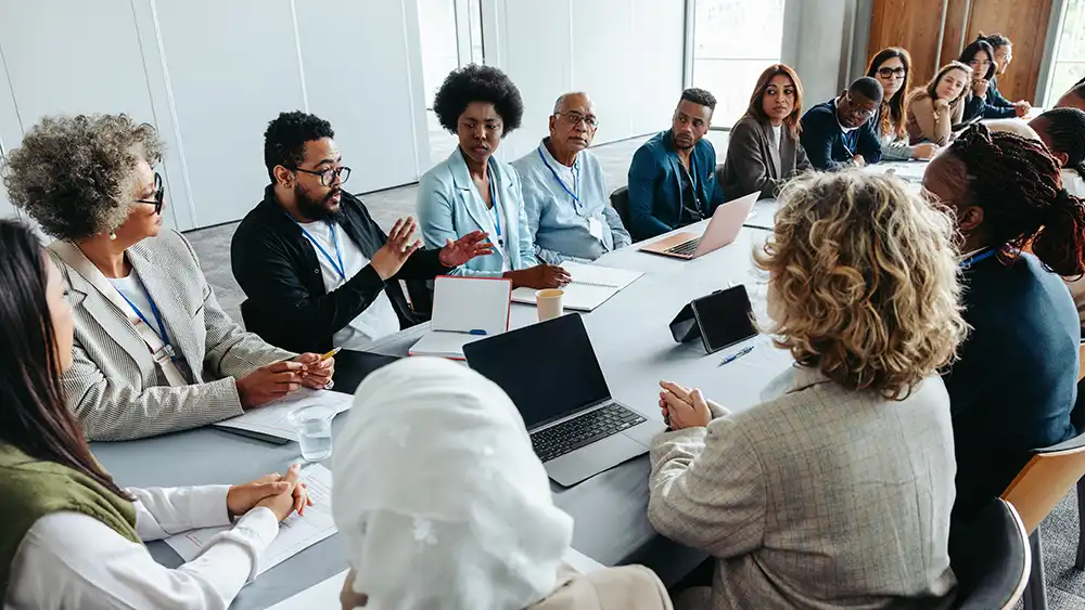 Executive staff around a conference table.