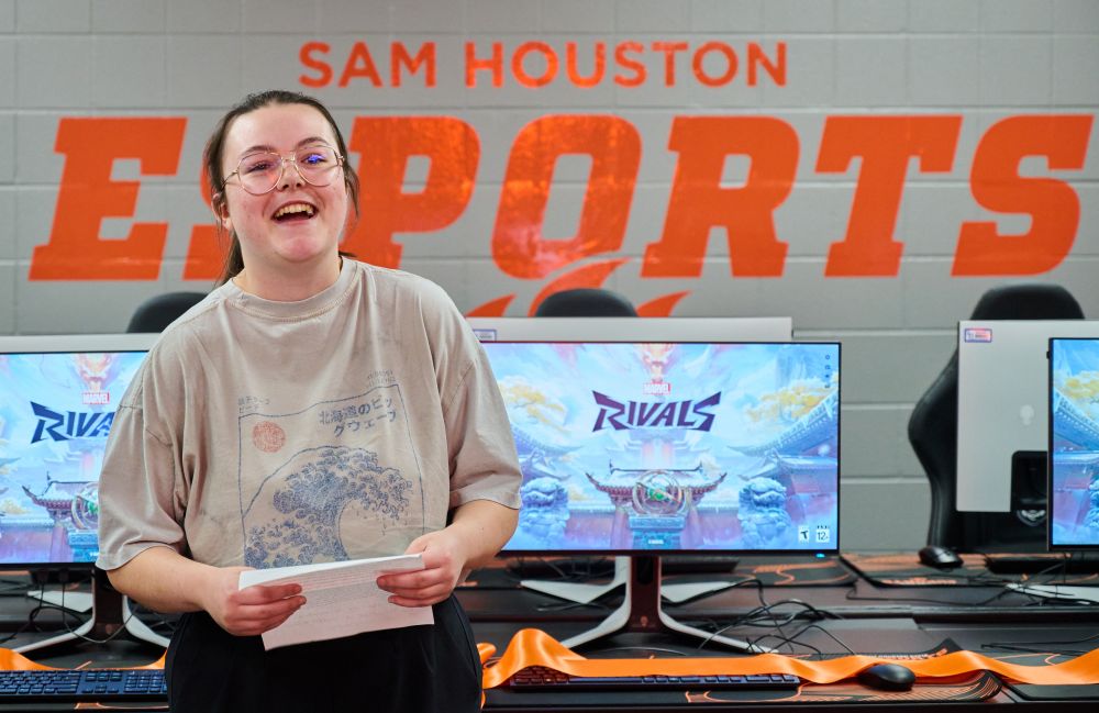student speaks at ribbon cutting for e sports lab