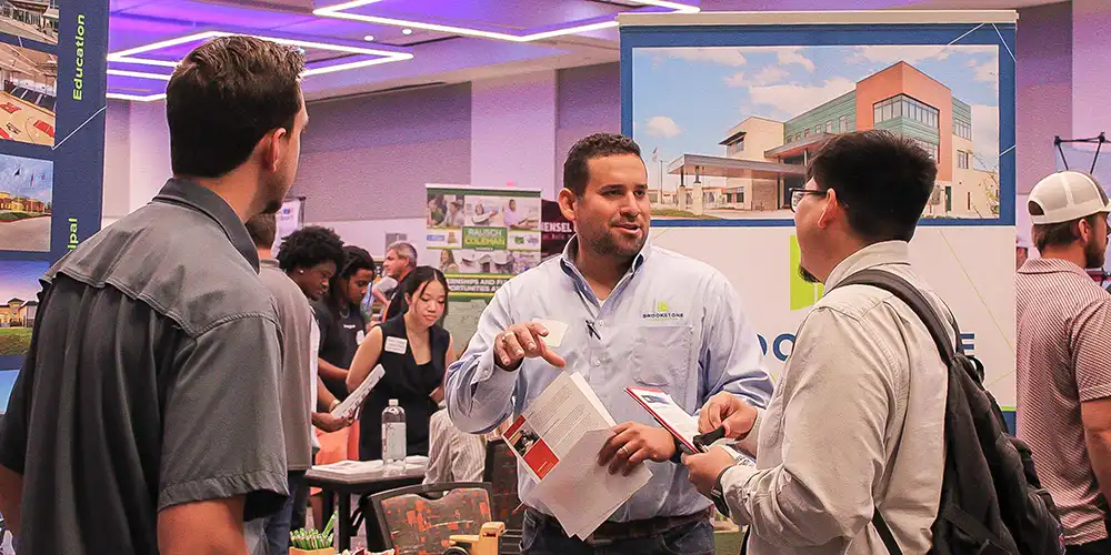 An SHSU student networking with a recruiter at a Career & Internship fair.