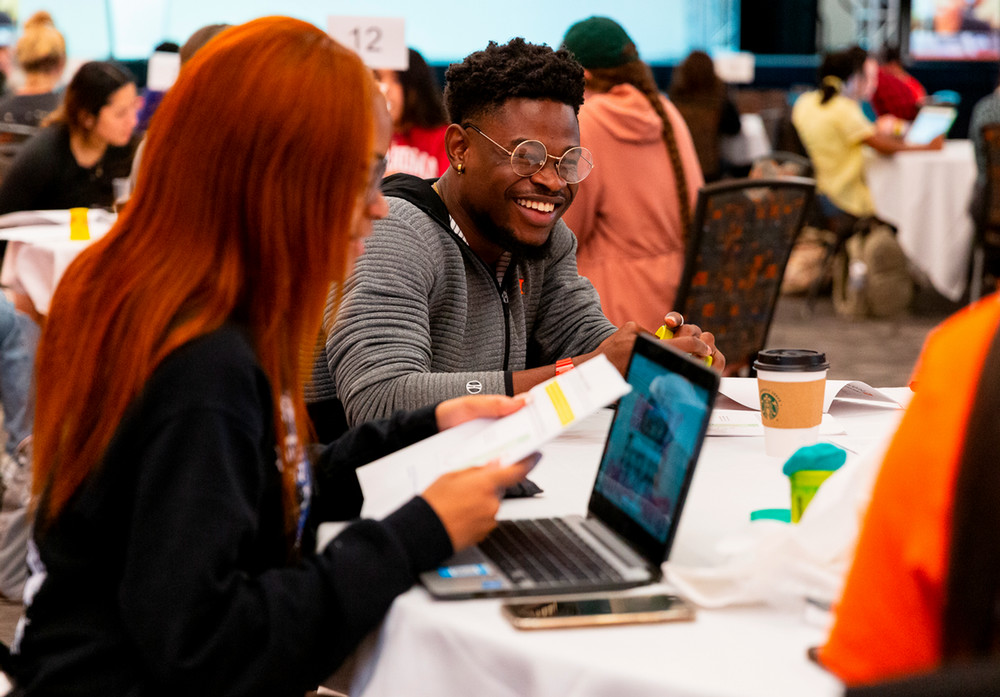 Student at table smiling