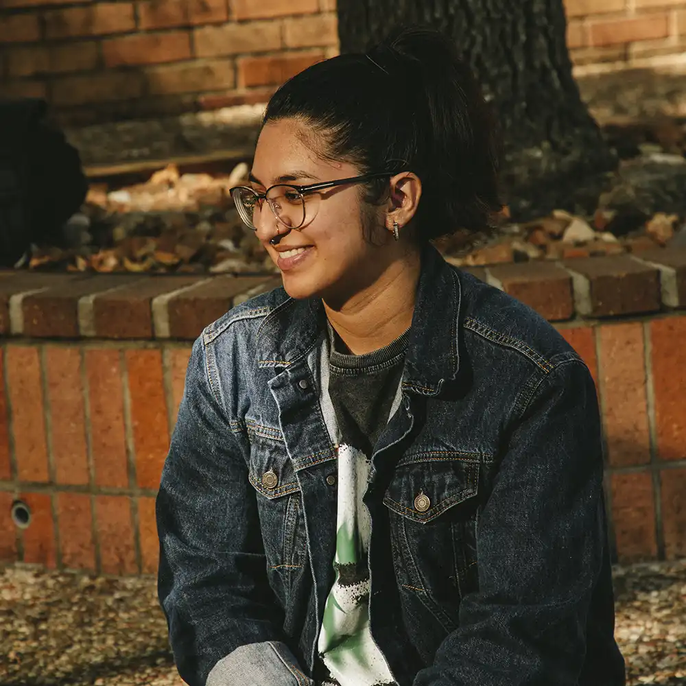 A girl with the quote, “without Freedom of Speech, there can be no change”