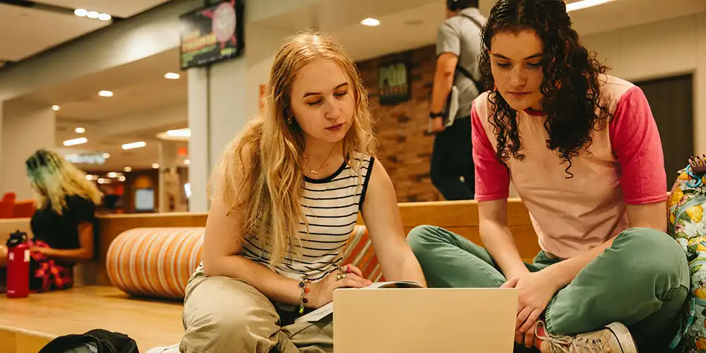 Two students looking at a computer