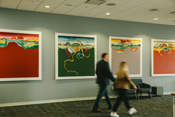 ​​Austin Hall at sunset illuminating behind statue of Sam Houston.​ 