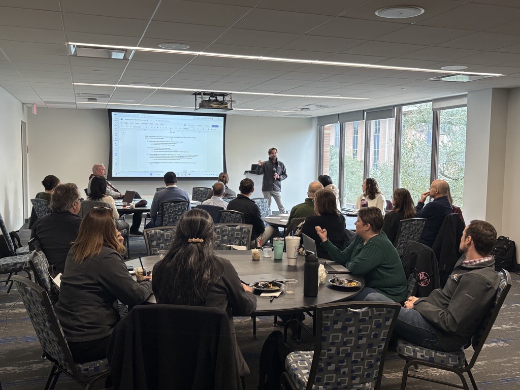 Group of people around a desk working together. 