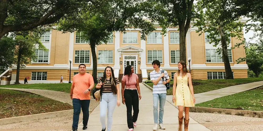 Group of students walking in front of building