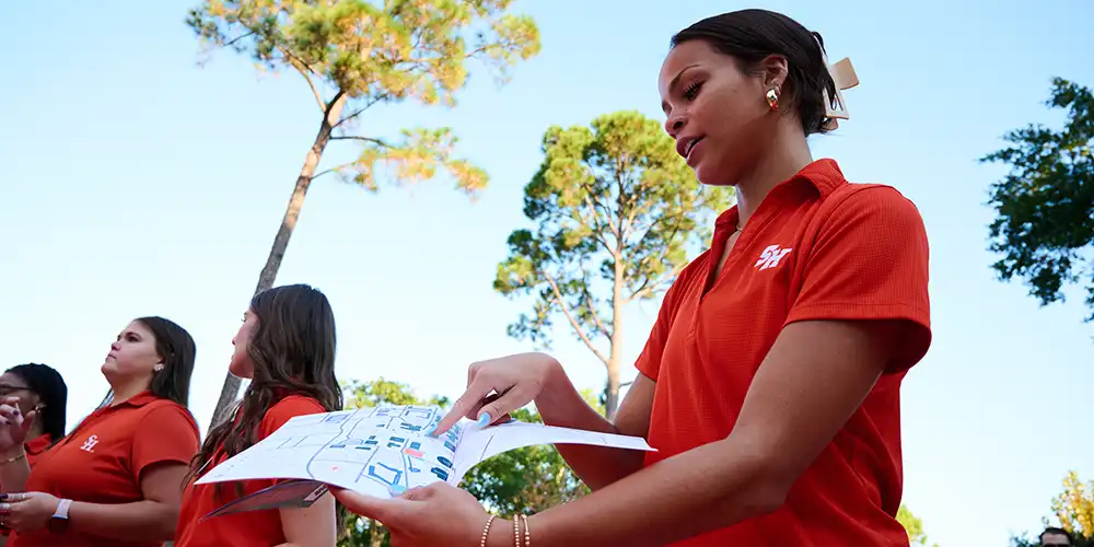 Volunteer showing visitor campus map